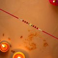 Red Bead Rakhi – Golden Centerpiece & Pearl Details (pack of 10)