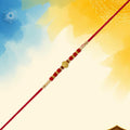 Red Bead Rakhi – Golden Centerpiece & Pearl Details (pack of 10)