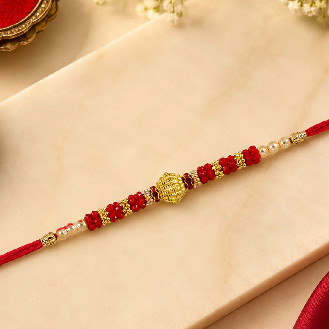 Red Bead Rakhi – Golden Centerpiece & Pearl Details (pack of 10)